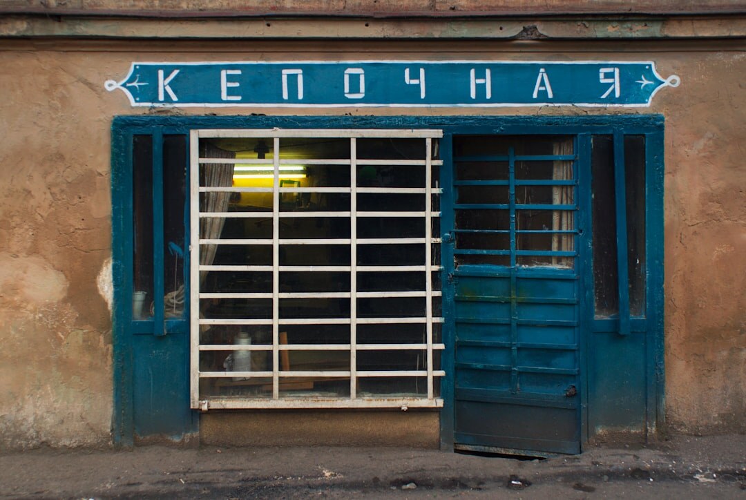 man with old shop facade
