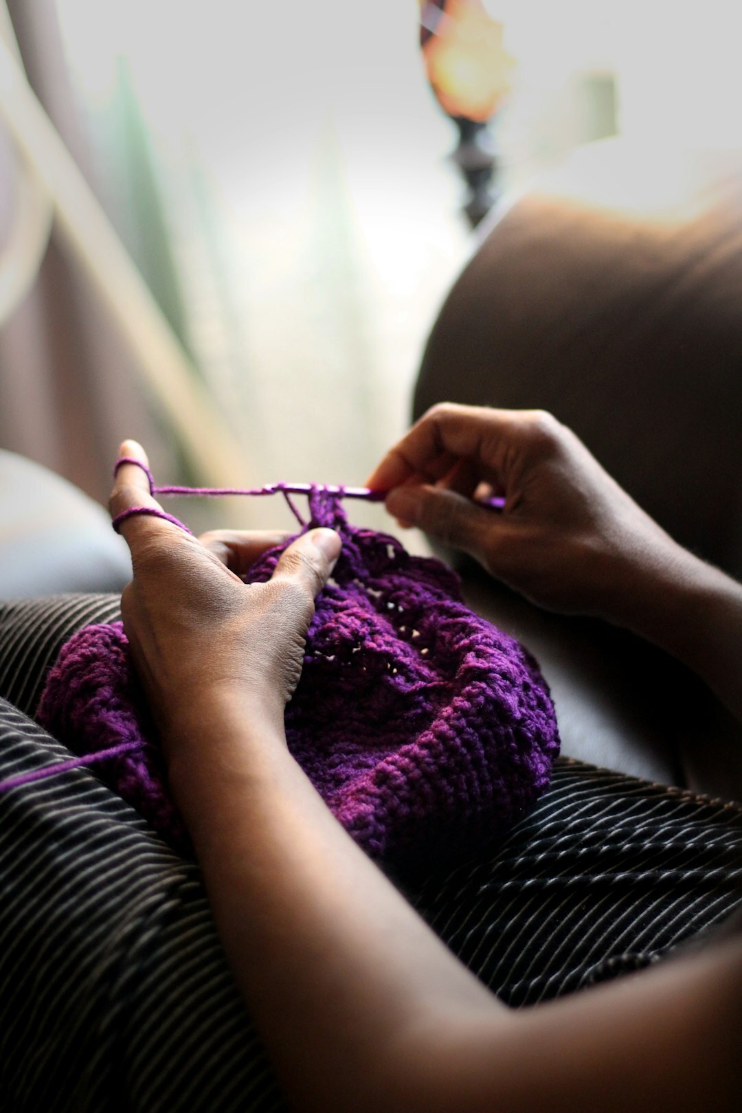Elderly Danish woman knitting by a window